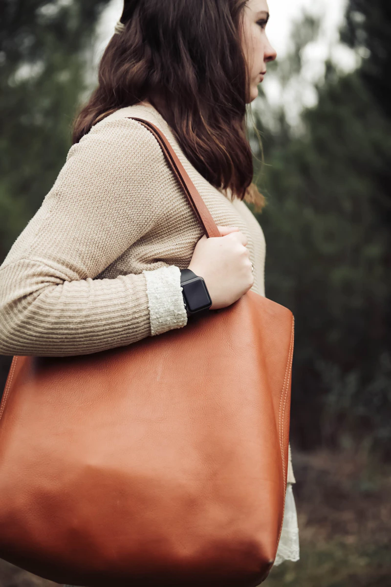 Leather tote bag carried over the shoulder, editorial