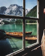 four brown wooden boat near dock