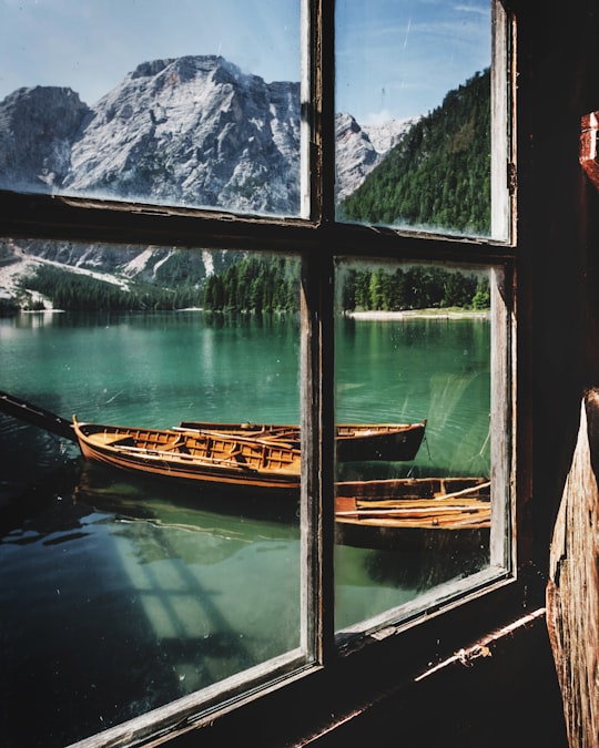 four brown wooden boat near dock in Parco naturale di Fanes-Sennes-Braies Italy