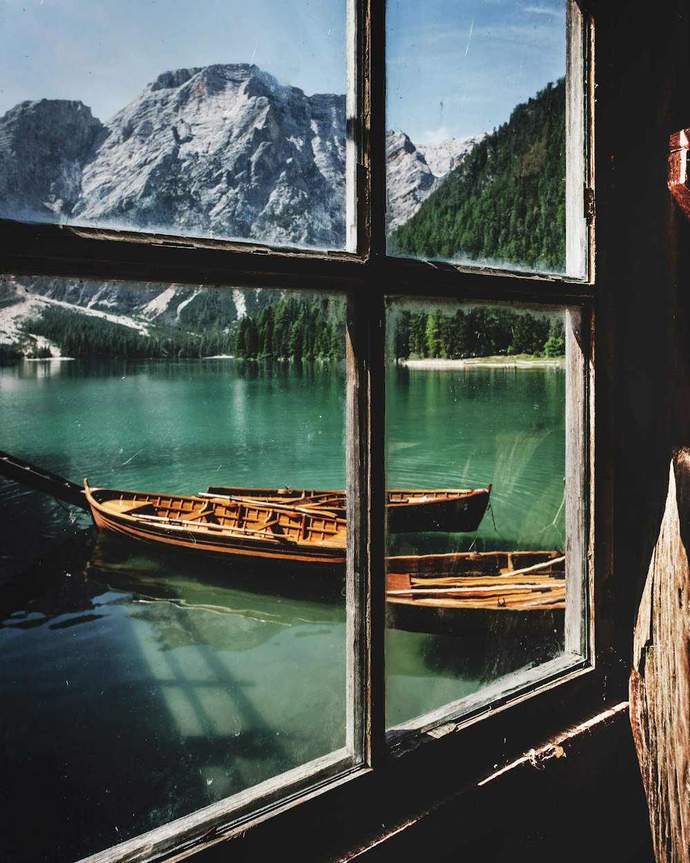 four brown wooden boat near dock