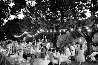 A joyful gathering of friends and family enjoying a beautifully decorated affordable event outdoors at sunset.