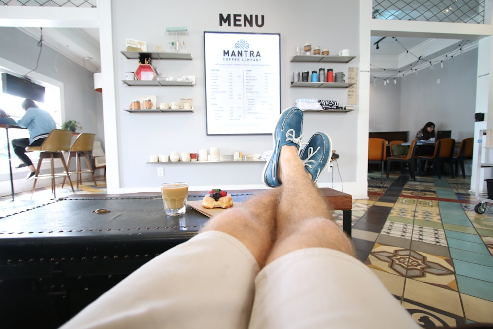 person in white shorts and blue and white nike sneakers