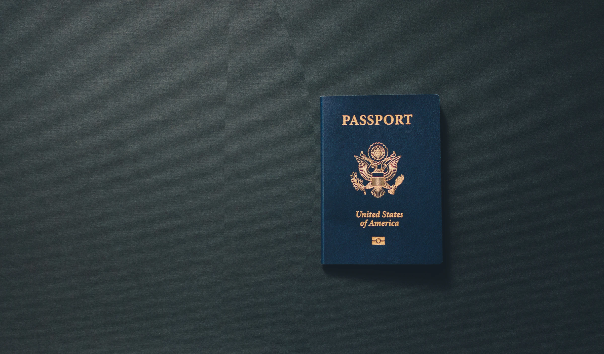 A passport on a dark desk