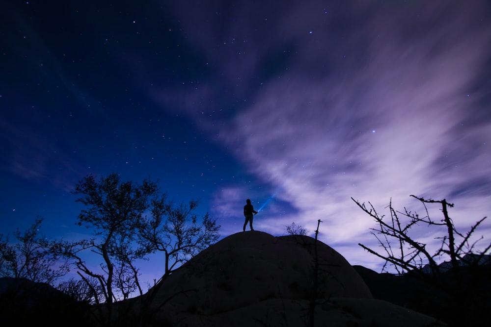 silhouette of a person on mountain hill