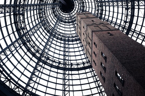 low-angel photography of gray concrete tower with windows