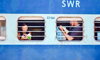 man and woman sitting on train