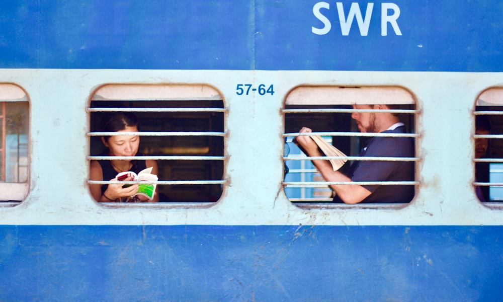 man and woman sitting on train