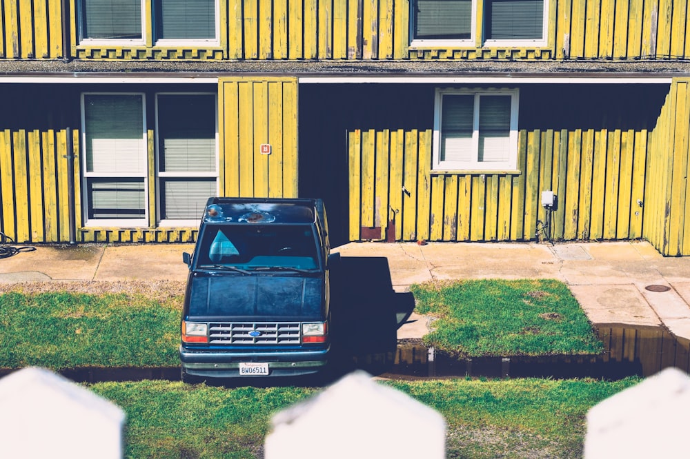 blue pickup truck packed on green grass