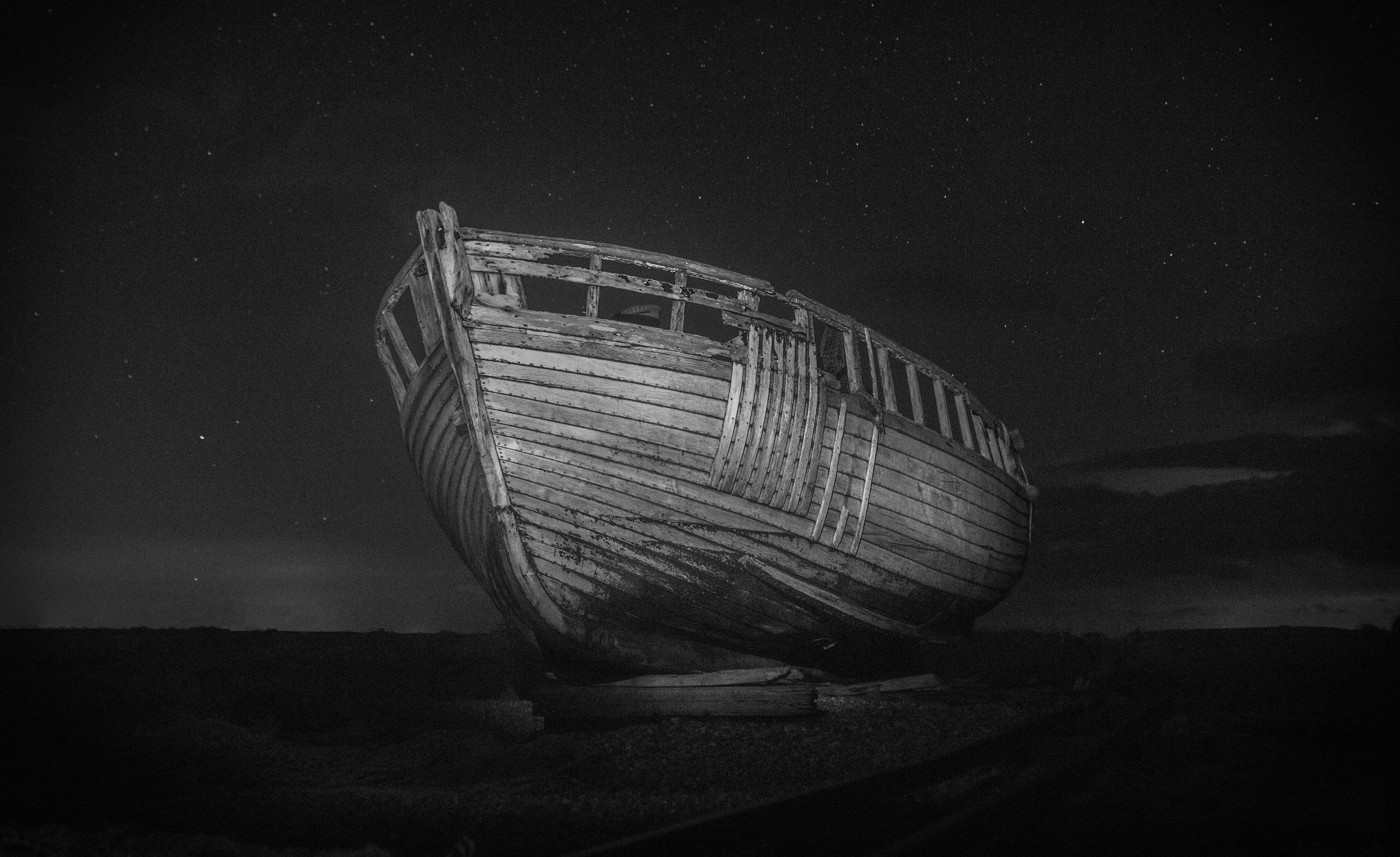 wrecked boat in monochrome photo
