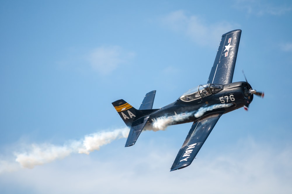 black biplane doing aerobatics