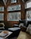 A cozy living room featuring handcrafted wooden furniture inspired by Mexican traditions.