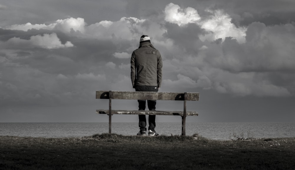 man standing near bench