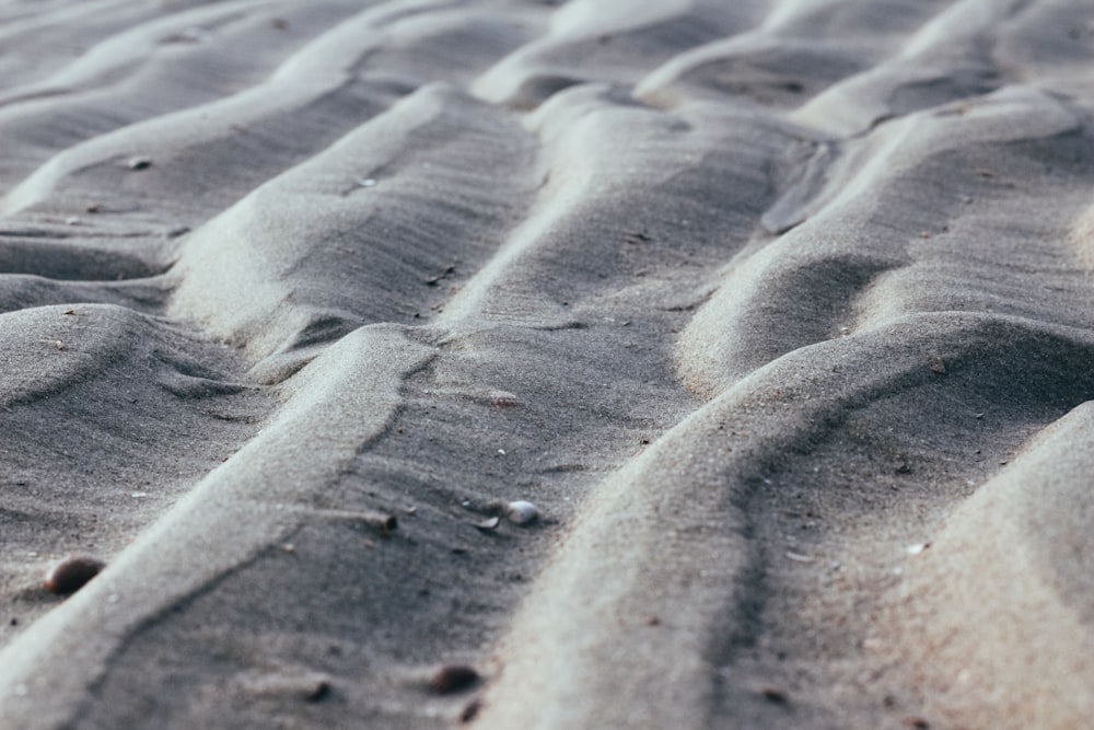 a close up of sand and water on a beach