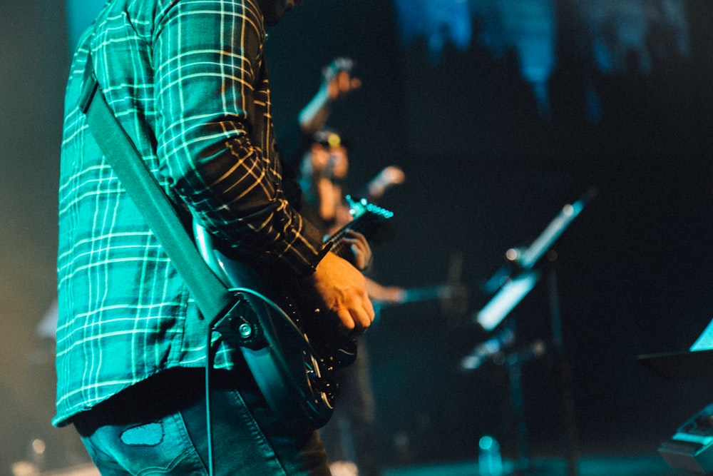 person playing electric guitar