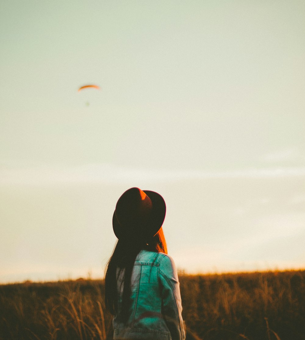 woman standing near green grass at daytime