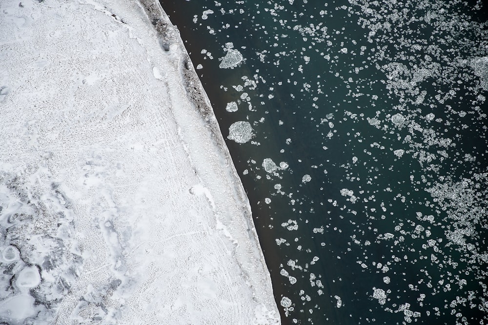 white boulder near body of water at daytime