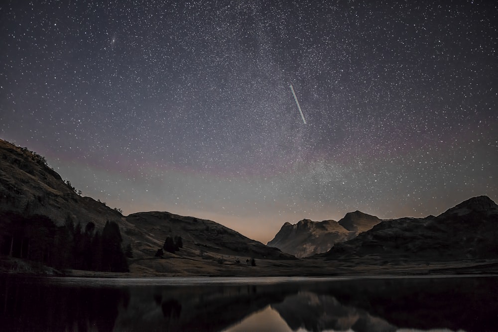 mountain silhouette during night time