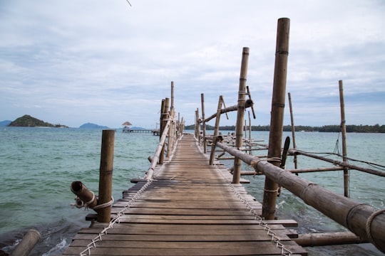 brown wooden dock on sea during daytime in Ko Mak Thailand