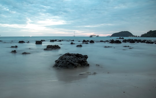 black rock formation on sea shore during daytime in Ko Mak Thailand