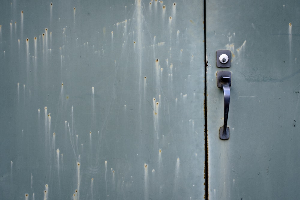 a close up of a door handle on a metal door