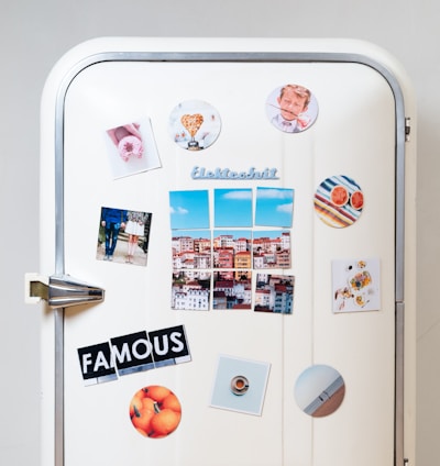 assorted-type photos stick on white single-door refrigerator