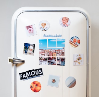 assorted-type photos stick on white single-door refrigerator