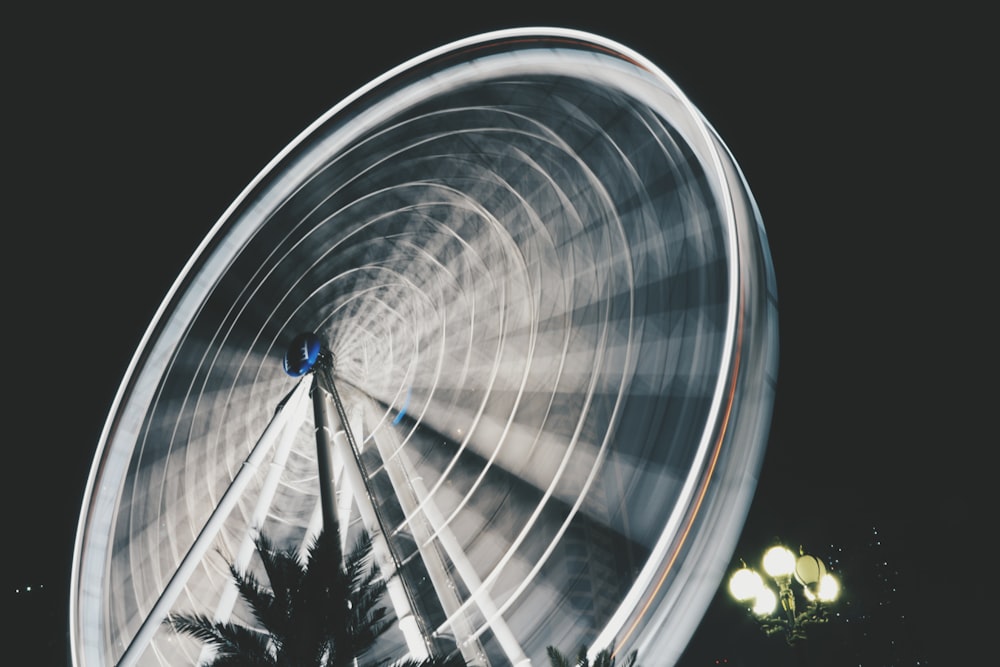time lapse photography of ferris wheel taken during night time
