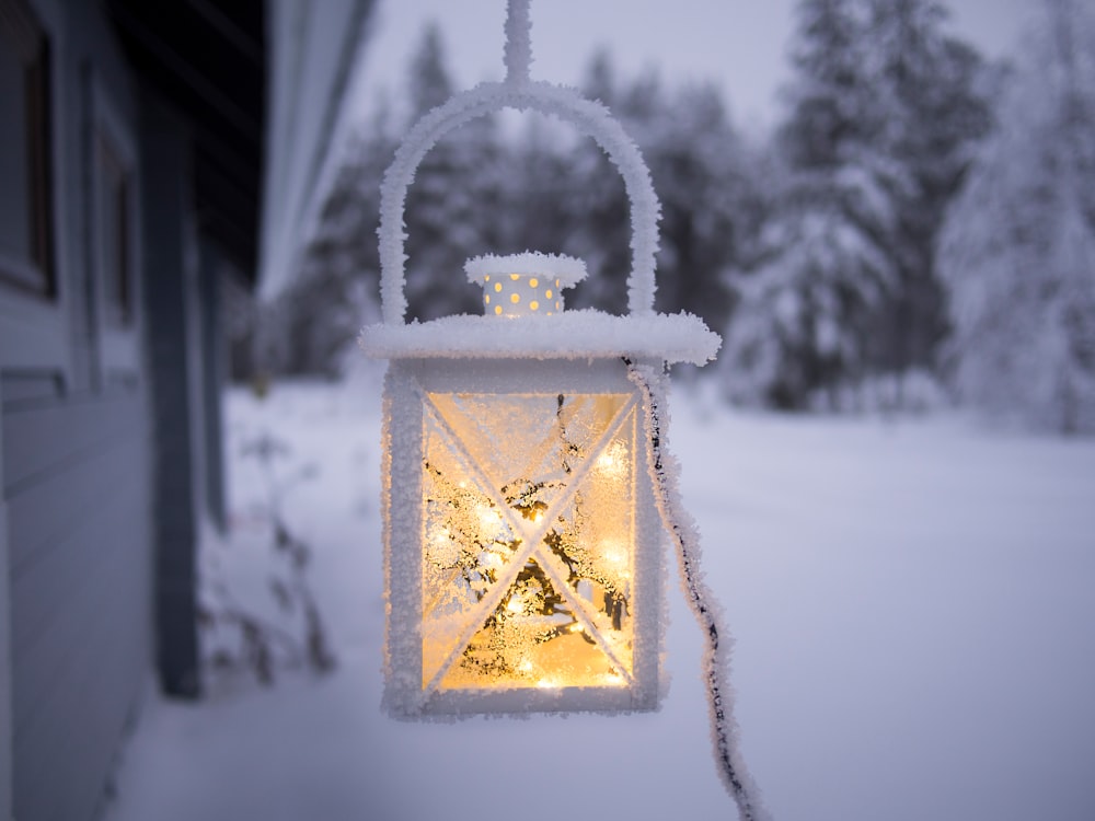 A snow covered lantern outside of a home in Sodankylä