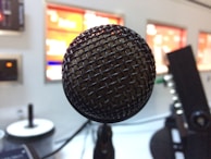 Close-up of a microphone with Radio Claires logo during a live show inside the studio.