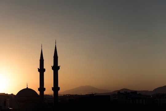 two mosque minarets under calm sky in Van Turkey