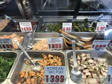 Colorful display of Arep Hoki’s menu items with prices on a modern digital screen.