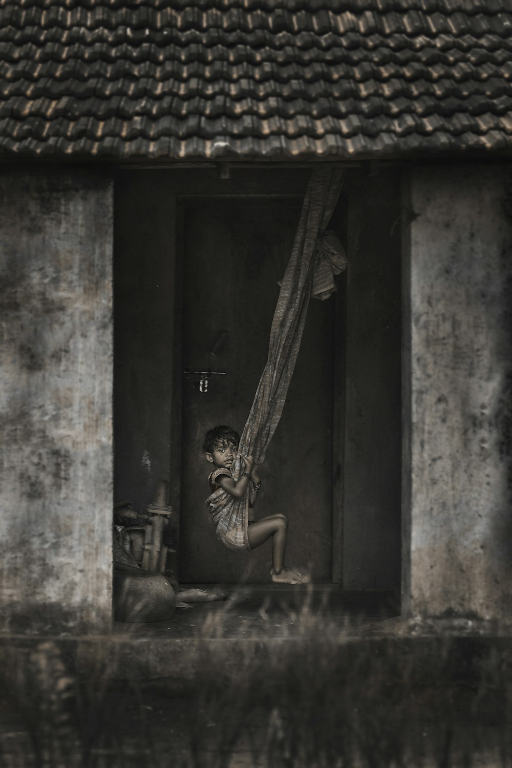 grayscale photo of girl riding hammock