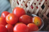 A close-up of ripe vegetables in a rustic basket.
