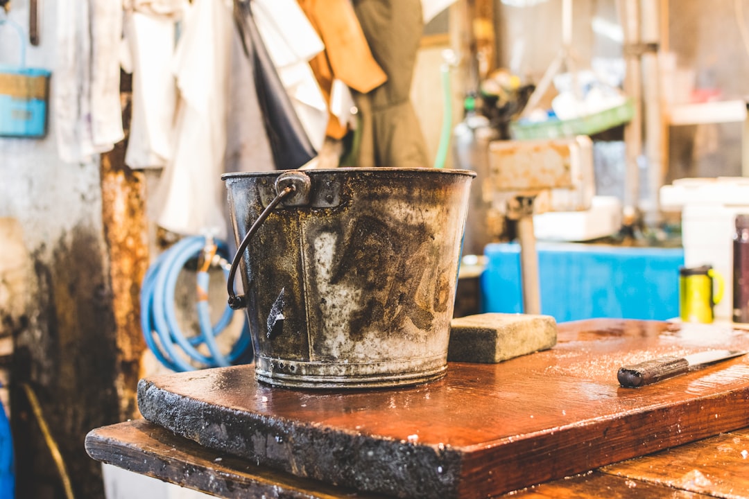 gray bucket on wooden table