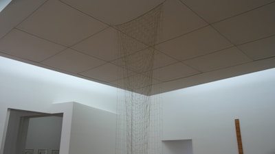 Elegant installation of modern art pieces arranged in a spacious white room.