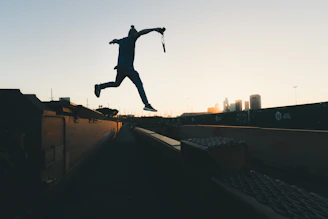 Jerry mid-air during a wire stunt against a city skyline backdrop.
