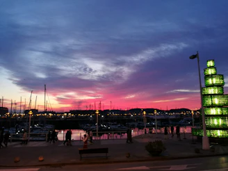 A vibrant marina at sunset with boats connected digitally through a glowing network overlay.