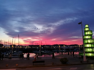 Sun Harbor Marina bustling with activity as the sun dips below the horizon, casting warm hues over the water.