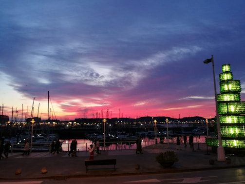 Sun Harbor Marina bustling with activity as the sun dips below the horizon, casting warm hues over the water.
