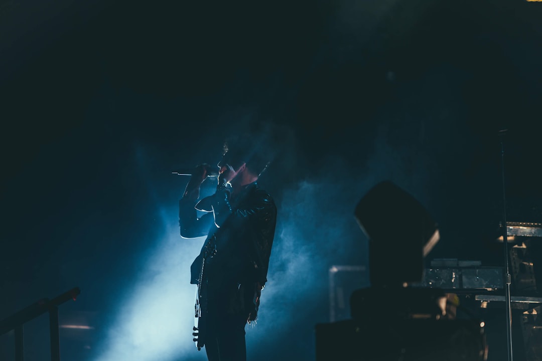 person holding microphone, Rockstar in blue smoke