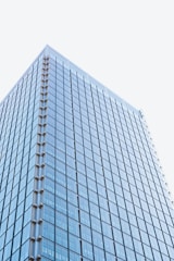 Contemporary commercial building reflecting city skyline glass.