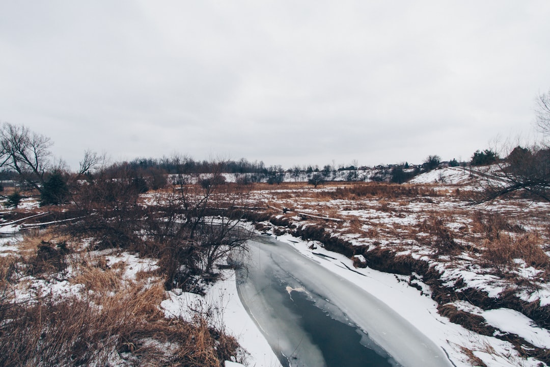 river covered snow under white sky