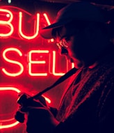 man standing in front of neon signage