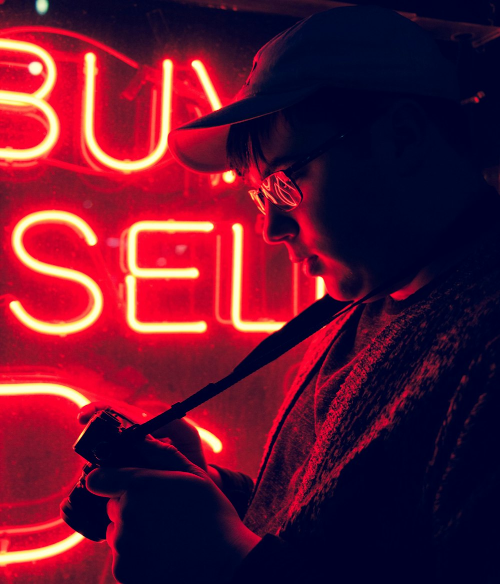 man standing in front of neon signage