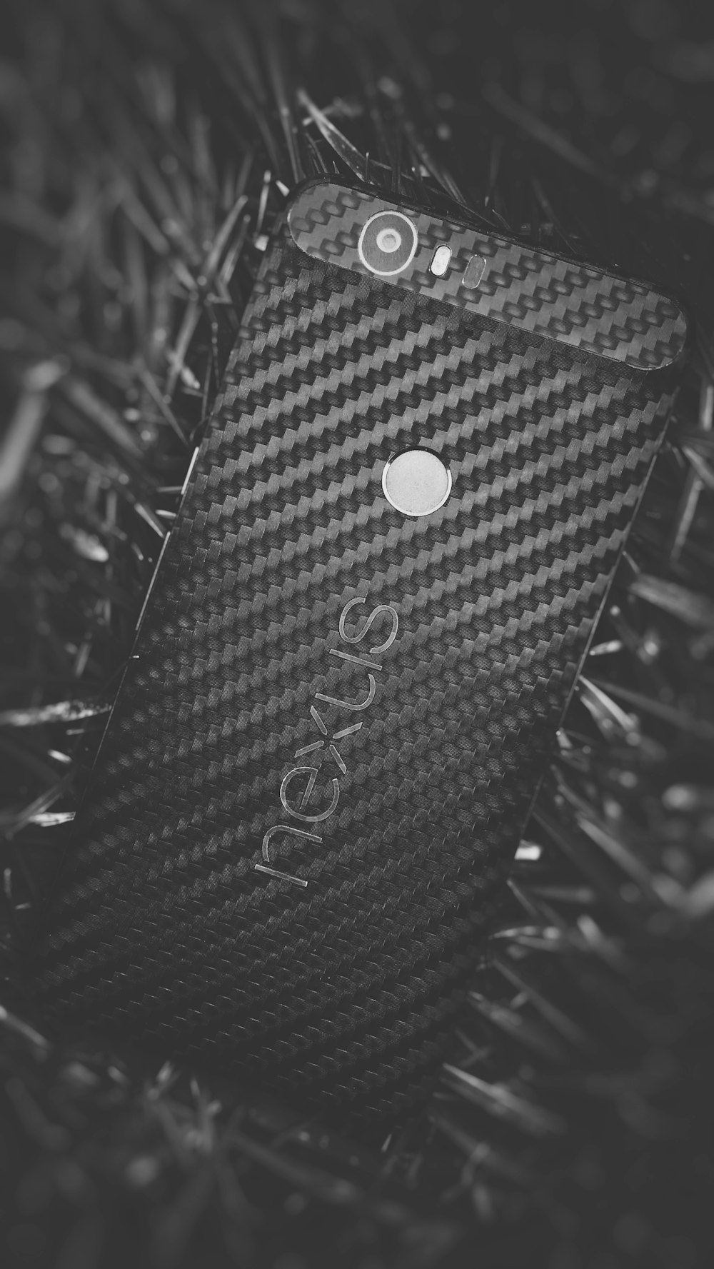 A black Nexus phone sitting on the ground.