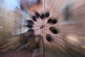 Modern kinetic sculpture with moving parts casting dynamic shadows on a white wall