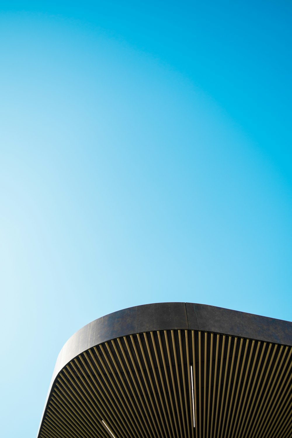 a clock on the side of a building under a blue sky