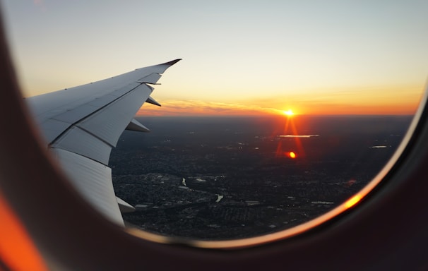 airplanes window view of sky during golden hour