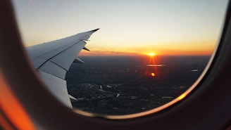 airplanes window view of sky during golden hour