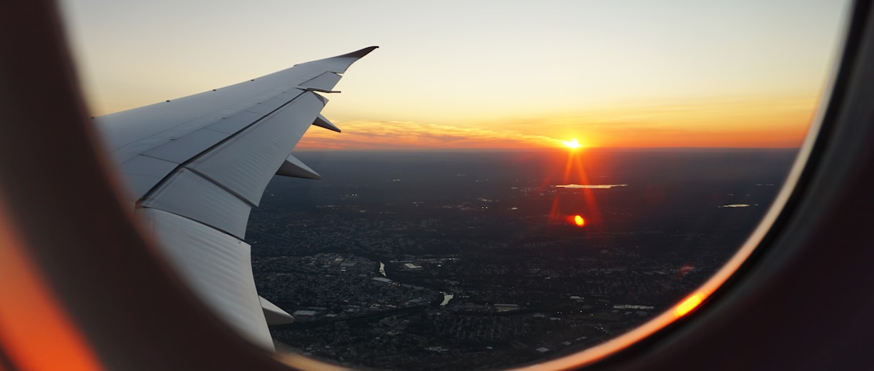 airplanes window view of sky during golden hour